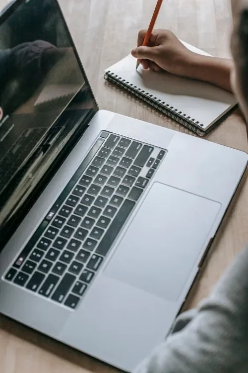 Learner studying online web development with a laptop